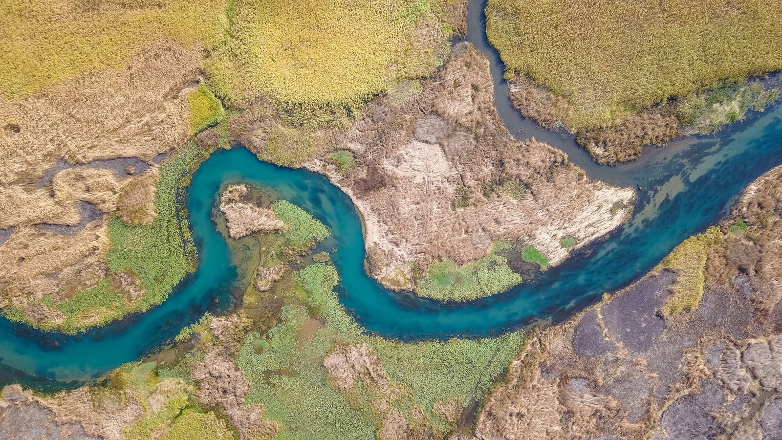 A river winding through farmland, seen from the air