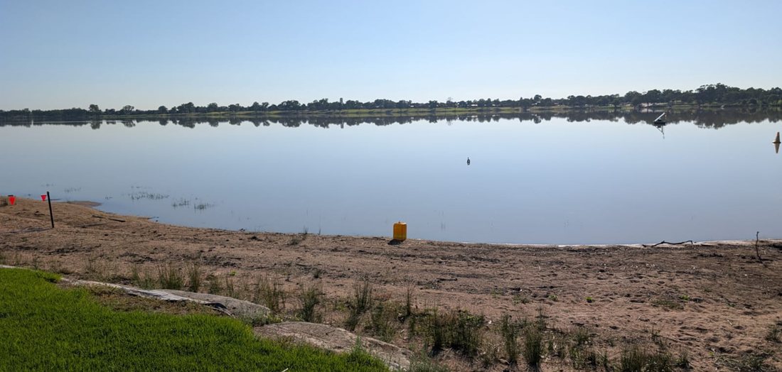 The Boat Club corner of Lake Albert with clear water and the far shore reflected in it