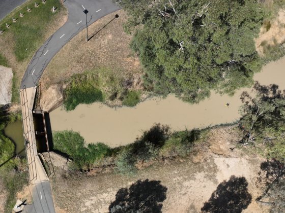 Drone view of the same channel and bridge with no visible bloom