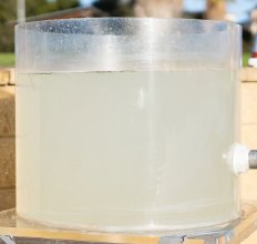 The same vessel holding water that is now pale and clear